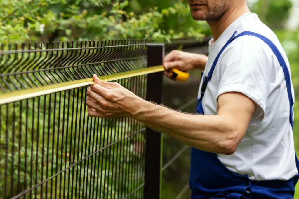 contractor performing a fence installation
